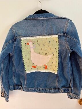 Upcycled Jean jacket with a quilted cowboy goose with lace on the back size smal